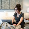 A girl typing on her laptop by wearing bra free dark grey inspirational T-shirt